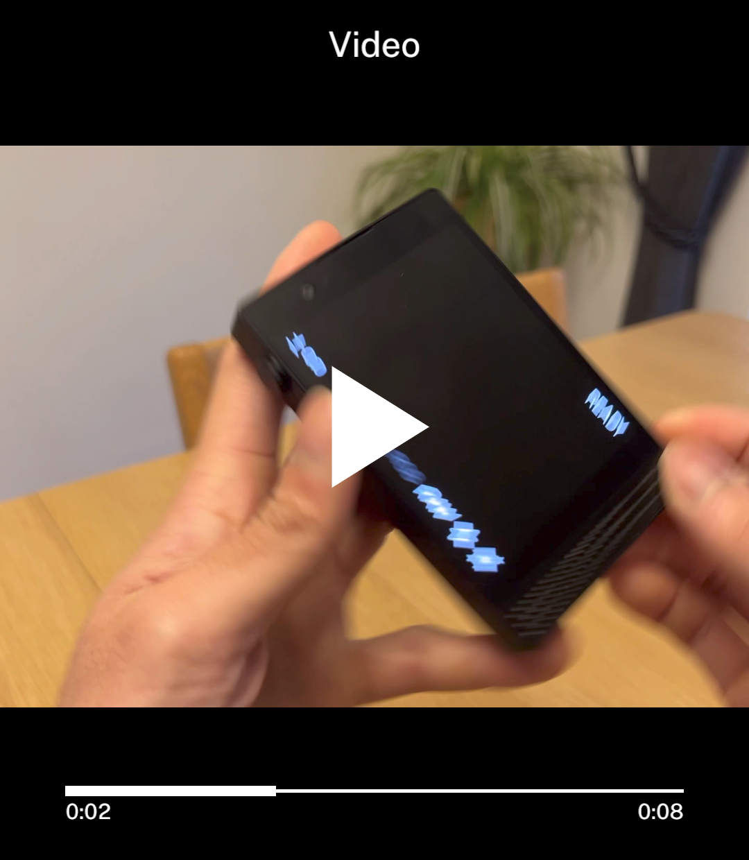 Paused video with a play icon in its centre.